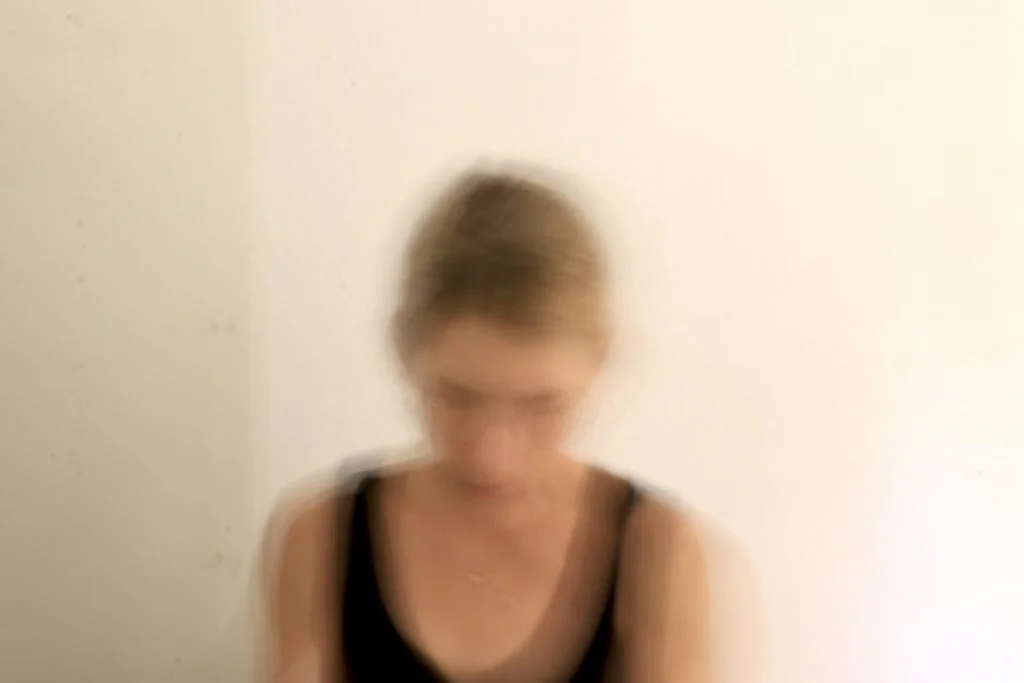 Woman in dark top photographed with a softly blurred background