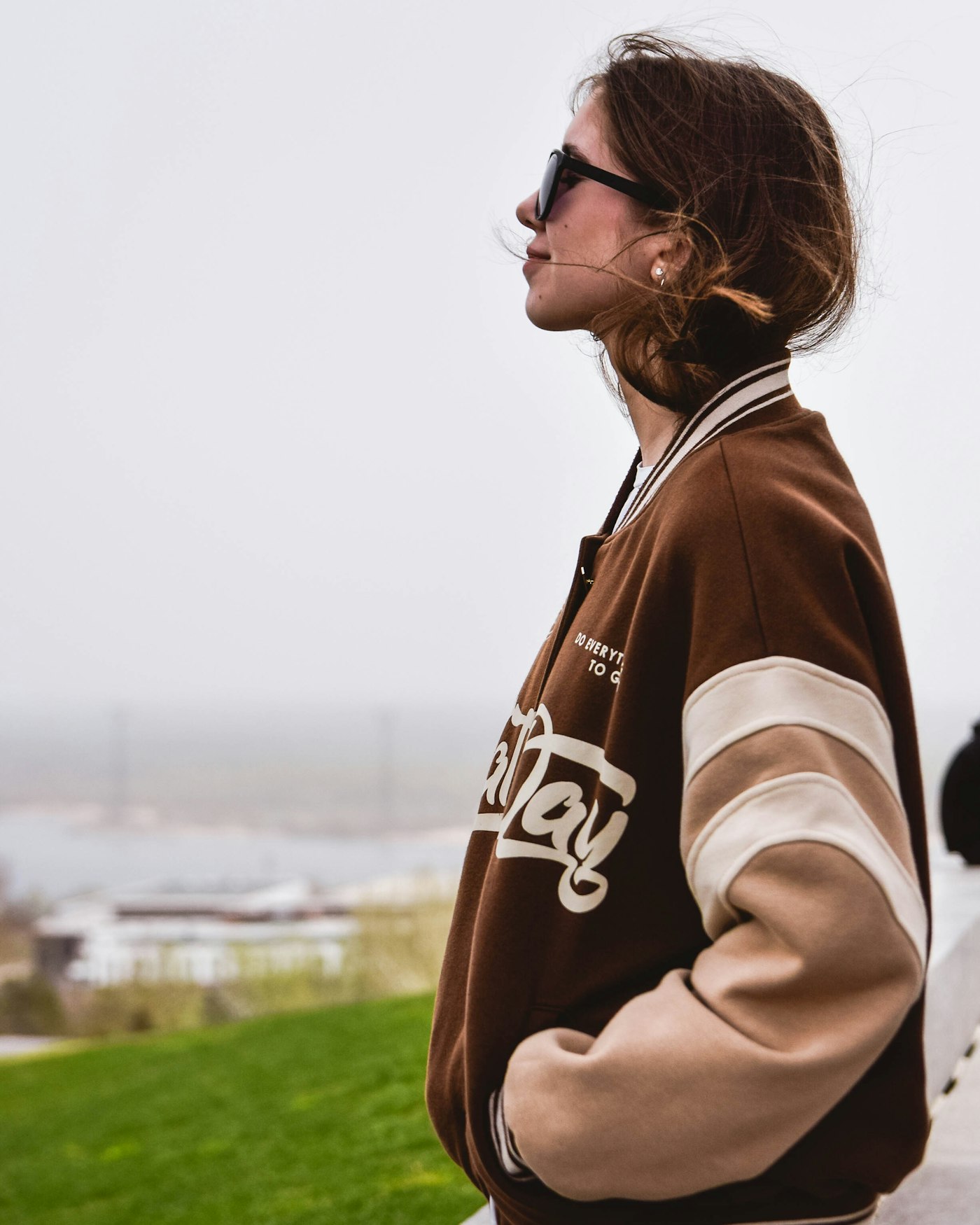 Person in jacket and sunglasses with smooth bokeh background behind