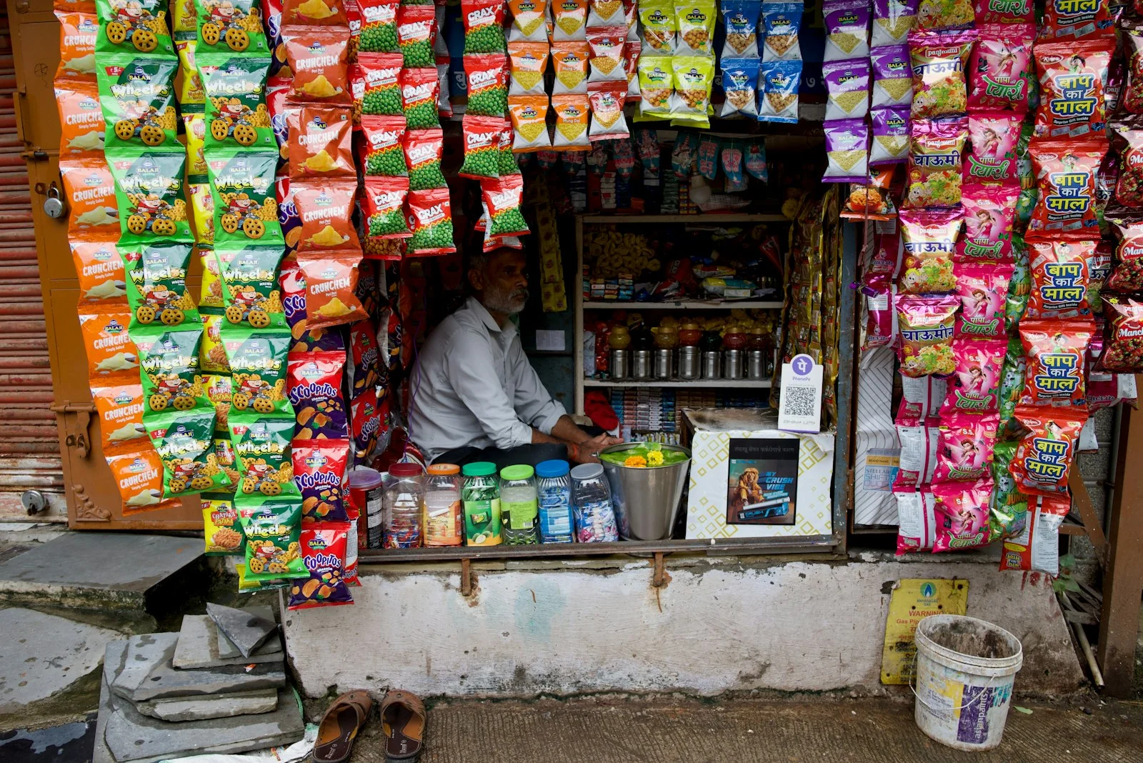 Small Indian shopkeeper at a counter handling goods subject to GST